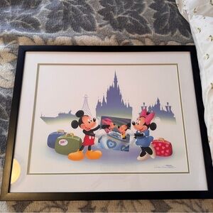 Framed photo of Mickey and Minnie Mouse.